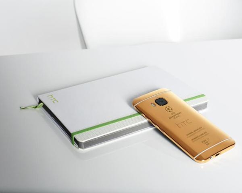 HTC ONE M9 in gold pictured with iPhone 1