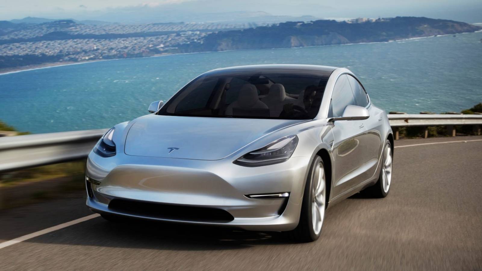 The Tesla Model 3 drives alone on the highway