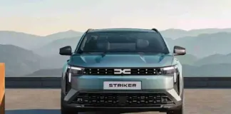 Front view of a silver SUV with a bold grille and 'STRIKER' license plate, mountains in the background.