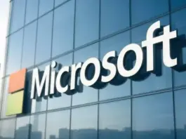 Microsoft logo displayed on a glass office building facade.