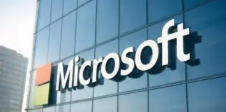 Microsoft logo displayed on a glass office building facade.