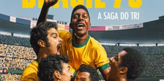 Soccer teammates in yellow jerseys celebrate a goal, lifting a player as a packed stadium cheers behind them.