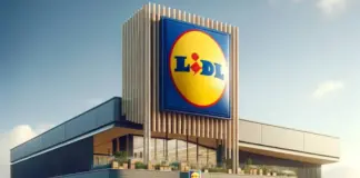 Lidl supermarket exterior with a tall sign displaying the blue and yellow Lidl logo against a clear sky