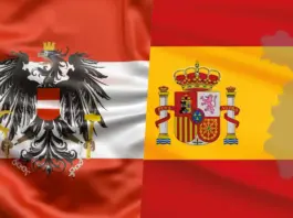 Overlap of Austria flag (red-white-red with black eagle) and Spain flag (yellow with coat of arms) on a single banner.