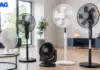 Row of different fans (standing and table models) in a bright, modern living room with an EMAG logo in the top-left corner.