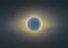 Total solar eclipse with the Moon fully covering the Sun and a glowing corona around the dark disc.