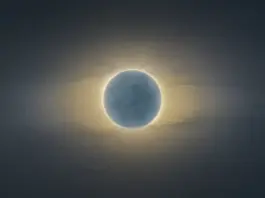 Total solar eclipse with the Moon fully covering the Sun and a glowing corona around the dark disc.