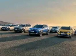 Row of modern SUVs lined up on a gravel surface at sunset, with mountains in the distance on the left.